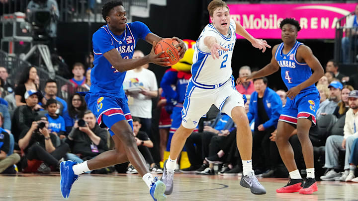 Nov 26, 2024; Las Vegas, Nevada, USA; Kansas Jayhawks forward Flory Bidunga (40) catches a loose ball against Duke Blue Devils guard Cooper Flagg (2) during the first half at T-Mobile Arena. Mandatory Credit: Stephen R. Sylvanie-Imagn Images