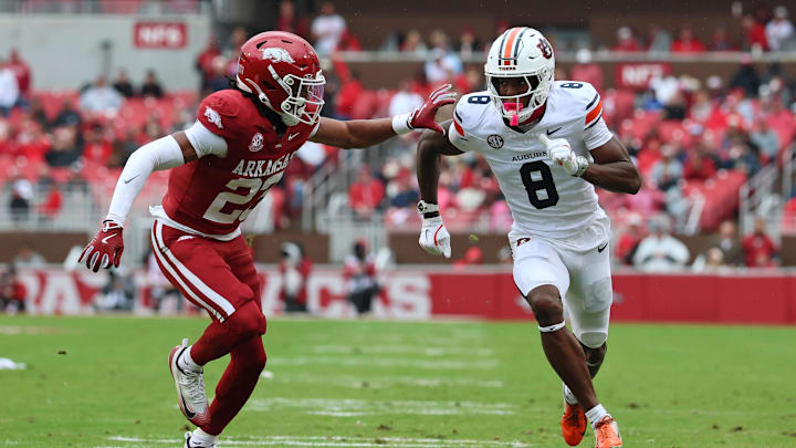 Oct 25, 2025; Fayetteville, Arkansas, USA; Auburn Tigers wide receiver Cam Coleman (8) runs a route resulting in a touchdown catch as Arkansas Razorbacks defensive back Julian Neal (23) defends during the first quarter at Donald W. Reynolds Razorback Stadium. Mandatory Credit: Nelson Chenault-Imagn Images Oct 25, 2025; Fayetteville, Arkansas, USA; Auburn Tigers wide receiver Cam Coleman (8) runs a route resulting in a touchdown catch as Arkansas Razorbacks defensive back Julian Neal (23) defends during the first quarter at Donald W. Reynolds Razorback Stadium. Mandatory Credit: Nelson Chenault-Imagn Images