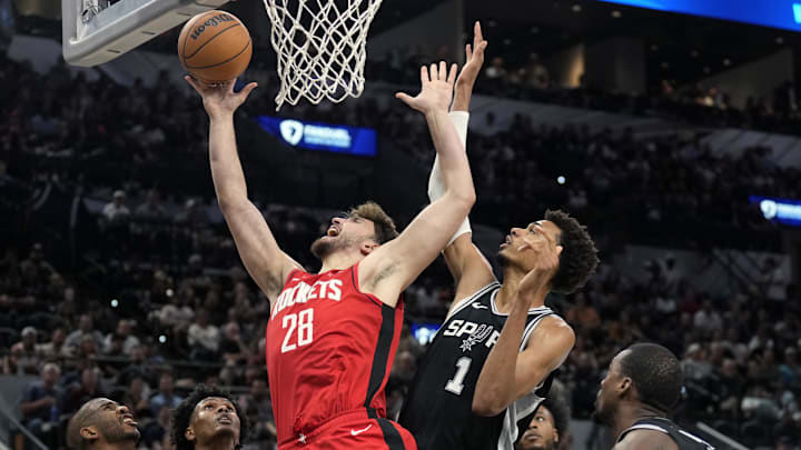 Oct 28, 2024; San Antonio, Texas, USA; Houston Rockets center Alperen Sengun (28) drives to the basket against center Victor Wembanyama (1) during the first half at Frost Bank Center. Mandatory Credit: Scott Wachter-Imagn Images