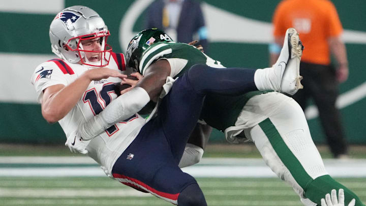 Sep 19, 2024; East Rutherford, New Jersey, USA; New England Patriots quarterback Drake Maye (10)  gets sacked hard by New York Jets linebacker Jamien Sherwood (44) in the 4th quarter at MetLife Stadium. Mandatory Credit: Robert Deutsch-Imagn Images