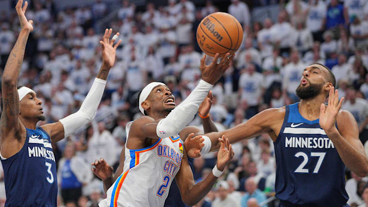 May 24, 2025; Minneapolis, Minnesota, USA; Oklahoma City Thunder guard Shai Gilgeous-Alexander (2) shoots the ball over Minnesota Timberwolves center Rudy Gobert (27) during the first half in game three of the western conference finals for the 2025 NBA Playoffs at Target Center. Mandatory Credit: Brad Rempel-Imagn Images May 24, 2025; Minneapolis, Minnesota, USA; Oklahoma City Thunder guard Shai Gilgeous-Alexander (2) shoots the ball over Minnesota Timberwolves center Rudy Gobert (27) during the first half in game three of the western conference finals for the 2025 NBA Playoffs at Target Center. Mandatory Credit: Brad Rempel-Imagn Images