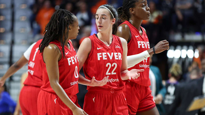 Sep 25, 2024; Uncasville, Connecticut, USA; Indiana Fever guard Caitlin Clark (22) talks to Indiana Fever guard Kelsey Mitchell (0) during the first half during game two of the first round of the 2024 WNBA Playoffs at Mohegan Sun Arena. Mandatory Credit: Paul Rutherford-Imagn Images