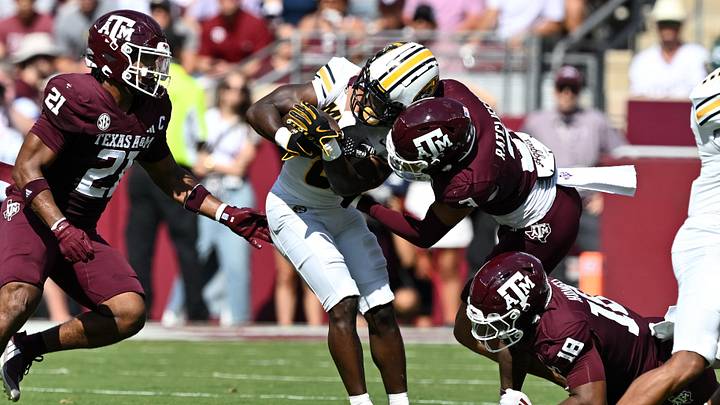 Texas A&M Aggies defensive back Marcus Ratcliffe tackles Missouri Tigers running back Nate Noel (8) in the first quarter at Kyle Field. 