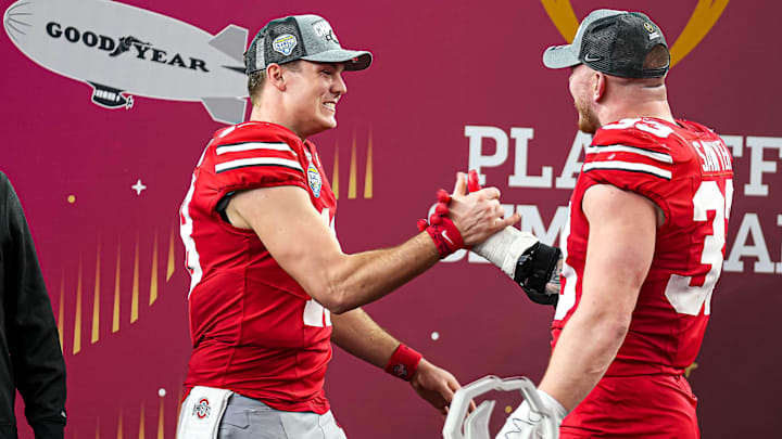 Ohio State quarterback Will Howard (18) and defensive end Jack Sawyer (33) celebrate the 28-14 win over the Texas Longhorns in the College Football Playoff semifinal game in the Cotton Bowl at AT&T Stadium on Friday, Jan. 10, 2024 in Arlington, Texas.