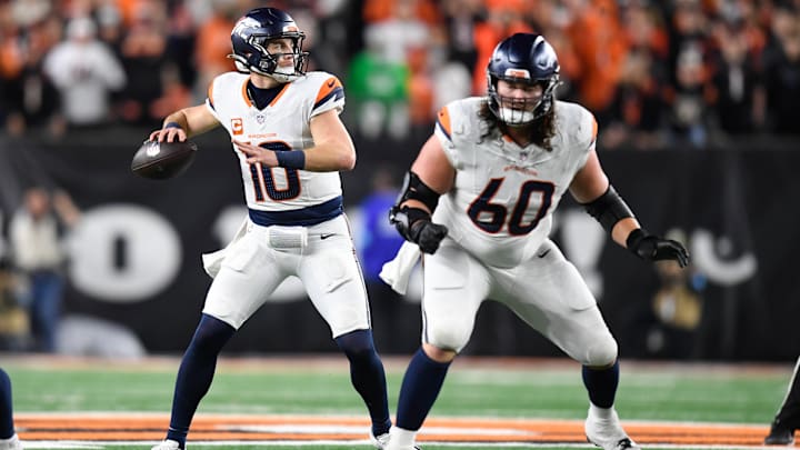 CINCINNATI, OH - DECEMBER 28: Denver Broncos Quarterback Bo Nix (10) passes as Denver Broncos Center Luke Wattenberg (60) blocks during the NFL, American Football Herren, USA football game between the Denver Broncos and the Cincinnati Bengals on December 28, 2024, at Paycor Stadium in Cincinnati, Ohio.