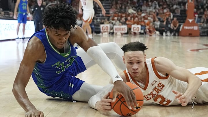 Dec 22, 2023; Austin, Texas, USA; Texas Longhorns guard Chendall Weaver (2) and Texas A&M Corpus Christi forward Garry Clark battle for a loose ball. 