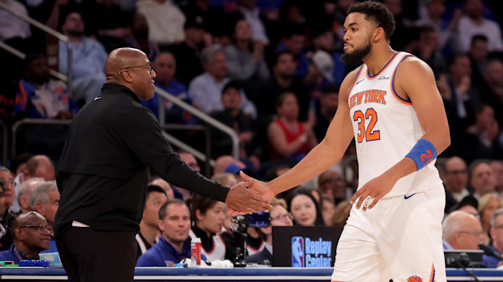 Oct 22, 2025; New York, New York, USA; New York Knicks head coach Mike Brown high fives center Karl-Anthony Towns (32) during the fourth quarter against the Cleveland Cavaliers at Madison Square Garden.