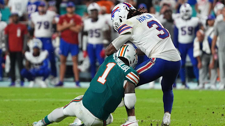Buffalo Bills safety Damar Hamlin (3) tackles Miami Dolphins quarterback Tua Tagovailoa (1) during the second half at Hard Rock Stadium. Buffalo Bills safety Damar Hamlin (3) tackles Miami Dolphins quarterback Tua Tagovailoa (1) during the second half at Hard Rock Stadium.