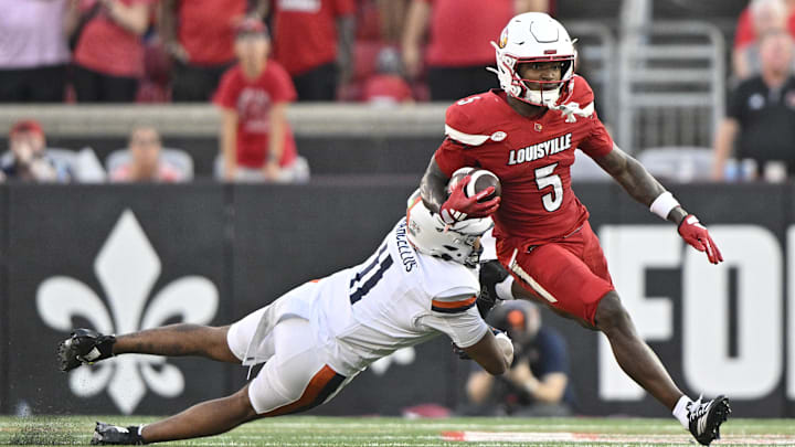 Oct 4, 2025; Louisville, Kentucky, USA; Louisville Cardinals wide receiver Caullin Lacy (5) runs the ball against Virginia Cavaliers linebacker Maddox Marcellus (11) during the second half at L&N Federal Credit Union Stadium. Virginia defeated Louisville 30-27. Mandatory Credit: Jamie Rhodes-Imagn Images Oct 4, 2025; Louisville, Kentucky, USA; Louisville Cardinals wide receiver Caullin Lacy (5) runs the ball against Virginia Cavaliers linebacker Maddox Marcellus (11) during the second half at L&N Federal Credit Union Stadium. Virginia defeated Louisville 30-27. Mandatory Credit: Jamie Rhodes-Imagn Images