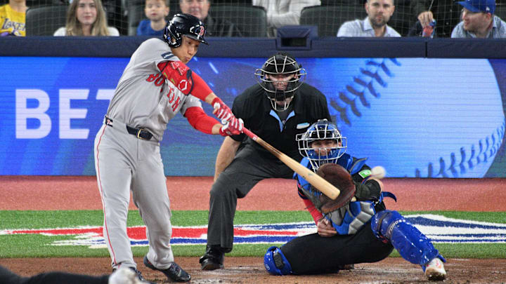 Sep 25, 2024; Toronto, Ontario, CAN;  Boston Red Sox designated hitter Masataka Yoshida (7) hits a double against the Toronto Blue Jays in the fourth inning at Rogers Centre. Mandatory Credit: Dan Hamilton-Imagn Images