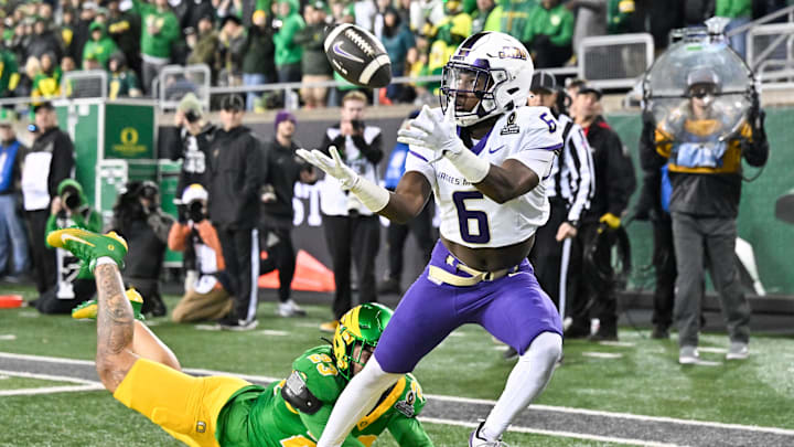 Dec 20, 2025; Eugene, OR, USA; James Madison Dukes running back George Pettaway (6) makes a catch for a touchdown as Oregon Ducks linebacker Brayden Platt (23) defends during the third quarter at Autzen Stadium. Mandatory Credit: Craig Strobeck-Imagn Images