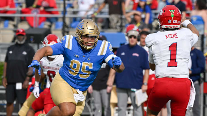 Nov 30, 2024; Pasadena, California, USA; UCLA Bruins defensive lineman Sitiveni Havili Kaufusi (95) pressures Fresno State Bulldogs quarterback Mikey Keene (1) during the second quarter at Rose Bowl. Mandatory Credit: Robert Hanashiro-Imagn Images