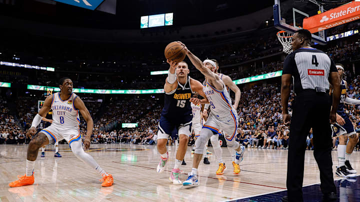 May 11, 2025; Denver, Colorado, USA; Denver Nuggets center Nikola Jokic (15) and Oklahoma City Thunder guard Alex Caruso (9) battle for a loose ball as forward Jalen Williams (8) and referee Sean Wright (4) look on in the fourth quarter during Game 4 of the second round at Ball Arena. Mandatory Credit: Isaiah J. Downing-Imagn Images May 11, 2025; Denver, Colorado, USA; Denver Nuggets center Nikola Jokic (15) and Oklahoma City Thunder guard Alex Caruso (9) battle for a loose ball as forward Jalen Williams (8) and referee Sean Wright (4) look on in the fourth quarter during Game 4 of the second round at Ball Arena. Mandatory Credit: Isaiah J. Downing-Imagn Images