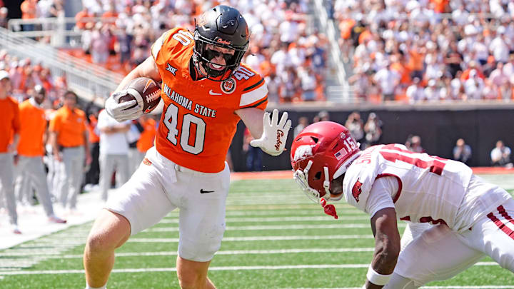 Oklahoma State's Josh Ford (40) looks to get past Arkansas' Jaheim Singletary (15) in the second half of the college football game between the Oklahoma State Cowboys and the Arkansas Razorbacks at Boone Pickens Stadium in Stillwater, Okla.,, Saturday, Sept., 7, 2024.