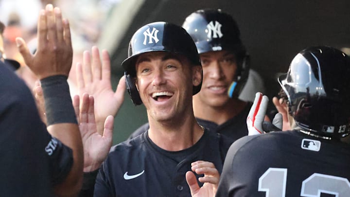 Mar 20, 2025; Sarasota, Florida, USA;  New York Yankees outfielder Cody Bellinger (35), New York Yankees third base Jazz Chisholm Jr. (13) and New York Yankees outfielder Aaron Judge (99) high five after scoring during the third inning against the Baltimore Orioles at Ed Smith Stadium.