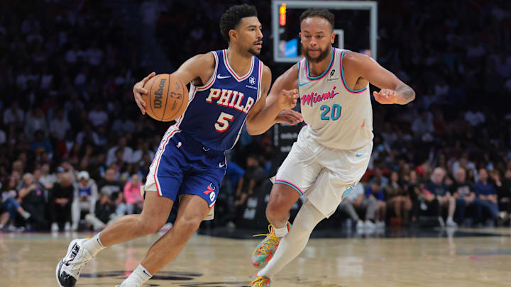 Apr 7, 2025; Miami, Florida, USA; Philadelphia 76ers guard Quentin Grimes (5) drives to the basket past Miami Heat forward Kyle Anderson (20) during the fourth quarter at Kaseya Center. Mandatory Credit: Sam Navarro-Imagn Images