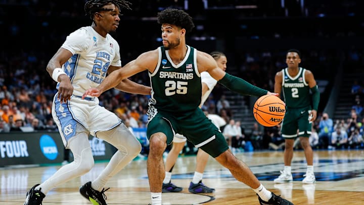 Michigan State forward Malik Hall (25) dribbles against North Carolina forward Jae'Lyn Withers (24) during the first half of the NCAA tournament West Region second round at Spectrum Center in Charlotte, N.C. on Saturday, March 23, 2024.