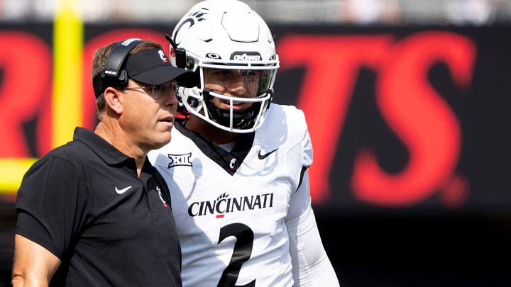 Cincinnati Bearcats head coach Scott Satterfield speaks to Cincinnati Bearcats quarterback Brendan Sorsby (2) in the second quarter of the College Football game between the Cincinnati Bearcats and the Towson Tigers at Nippert Stadium in Cincinnati on Saturday, Aug. 31, 2024. Cincinnati Bearcats head coach Scott Satterfield speaks to Cincinnati Bearcats quarterback Brendan Sorsby (2) in the second quarter of the College Football game between the Cincinnati Bearcats and the Towson Tigers at Nippert Stadium in Cincinnati on Saturday, Aug. 31, 2024.