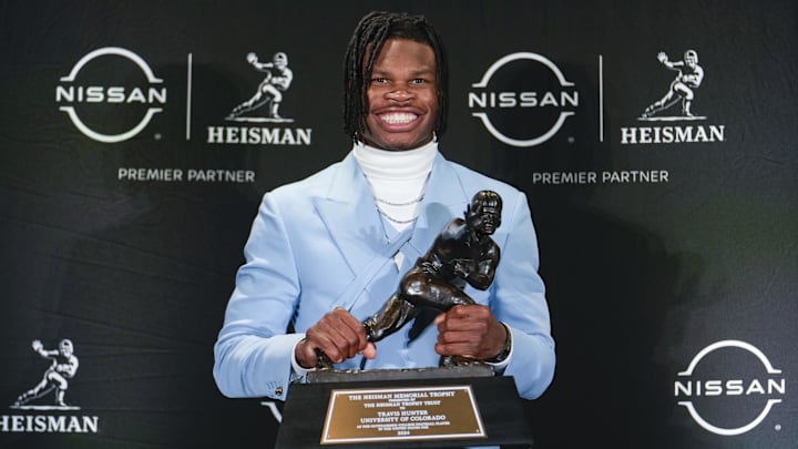 Dec 14, 2024; New York, NY, USA; Colorado Buffaloes wide receiver/cornerback Travis Hunter poses for a photo after winning the Heisman Trophy award during the 2024 Heisman Trophy Presentation. Mandatory Credit: Lucas Boland-Imagn Images