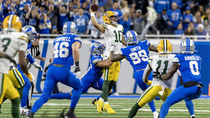 Dec 5, 2024; Detroit, Michigan, USA; Green Bay Packers quarterback Jordan Love (10) is pressured by Detroit Lions linebacker Ezekiel Turner (47) and defensive end Za'Darius Smith (99) during the first half at Ford Field. Mandatory Credit: David Reginek-Imagn Images