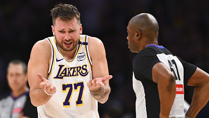Mar 22, 2025; Los Angeles, California, USA; Los Angeles Lakers guard Luka Doncic (77) reacts to a call from referee Courtney Kirkland (61) against the Chicago Bulls during the second half at Crypto.com Arena. Mandatory Credit: Jonathan Hui-Imagn Images