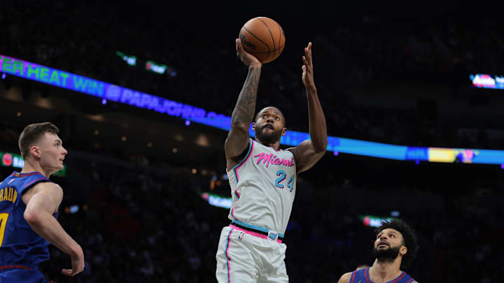 Jan 17, 2025; Miami, Florida, USA; Miami Heat forward Haywood Highsmith (24) shoots the basketball past Denver Nuggets guard Jamal Murray (27) during the third quarter at Kaseya Center. Mandatory Credit: Sam Navarro-Imagn Images