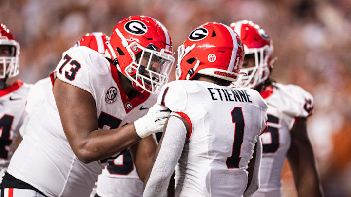Oct 19, 2024; Austin, Texas, USA; Georgia Bulldogs running back Trevor Etienne (1) celebrates with offensive lineman Xavier Truss (73) after scoring a touchdown against the Texas Longhorns during the second quarter at Darrell K Royal-Texas Memorial Stadium. Mandatory Credit: Brett Patzke-Imagn Images