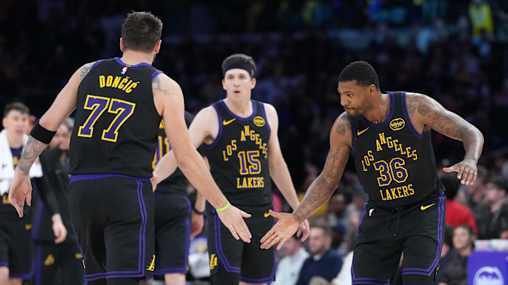 Mar 3, 2026; Los Angeles, California, USA; Los Angeles Lakers guard Luka Doncic (77), guard Austin Reaves (15) and guard Marcus Smart (36) react against the New Orleans Pelicans in the second half at Crypto.com Arena. Mandatory Credit: Kirby Lee-Imagn Images