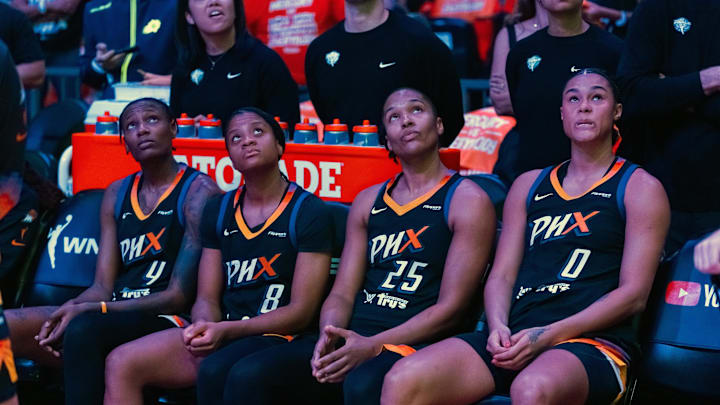 Oct 8, 2025; Phoenix, Arizona, USA; Phoenix Mercury forward Natasha Mack (4), guard Monique Akoa Makani (8), forward Alyssa Thomas (25) and forward Satou Sabally (0) sit on the bench against the Las Vegas Aces during game three of the 2025 WNBA Finals at PHX Arena. Mandatory Credit: Mark J. Rebilas-Imagn Images Oct 8, 2025; Phoenix, Arizona, USA; Phoenix Mercury forward Natasha Mack (4), guard Monique Akoa Makani (8), forward Alyssa Thomas (25) and forward Satou Sabally (0) sit on the bench against the Las Vegas Aces during game three of the 2025 WNBA Finals at PHX Arena. Mandatory Credit: Mark J. Rebilas-Imagn Images