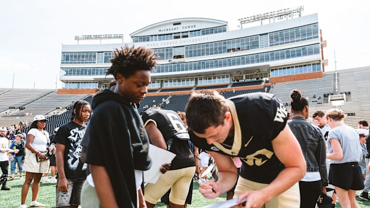 Wake Forest kicker Connor Calvert signs autographs for fans after Spring Fan Fest 