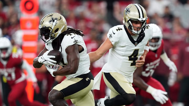Aug 10, 2024; Glendale, Arizona, USA; New Orleans Saints quarterback Derek Carr (4) hands the ball to New Orleans Saints running back Alvin Kamara (41) during the first half against the Arizona Cardinals at State Farm Stadium. Mandatory Credit: Joe Camporeale-Imagn Images Aug 10, 2024; Glendale, Arizona, USA; New Orleans Saints quarterback Derek Carr (4) hands the ball to New Orleans Saints running back Alvin Kamara (41) during the first half against the Arizona Cardinals at State Farm Stadium. Mandatory Credit: Joe Camporeale-Imagn Images