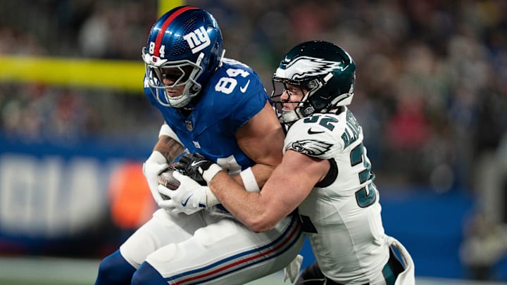 New York Giants tight end Theo Johnson (84) catches a pass before being tackled by Philadelphia Eagles safety Reed Blankenship (32) during a Thursday Night Football game between the New York Giants and the Philadelphia Eagles at MetLife Stadium in East Rutherford on Oct. 9, 2025.