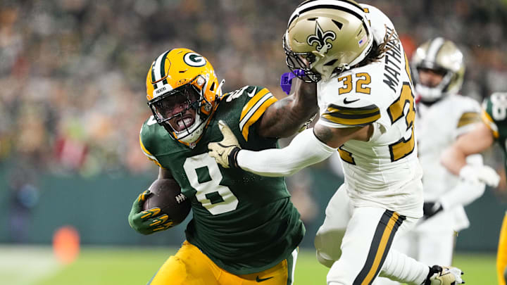 Green Bay Packers running back Josh Jacobs (8) stiff-arms New Orleans Saints safety Tyrann Mathieu (32) during the first quarter.