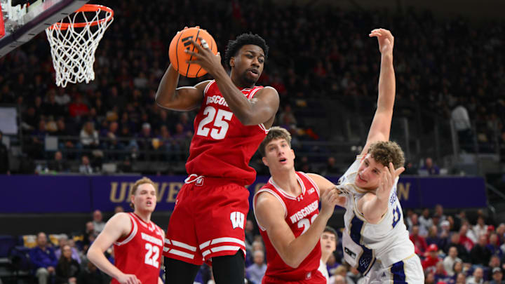 Feb 28, 2026; Seattle, Washington, USA; Wisconsin Badgers guard John Blackwell (25) rebounds the ball against the Washington Huskies during the first half at Alaska Airlines Arena at Hec Edmundson Pavilion. Mandatory Credit: Steven Bisig-Imagn Images