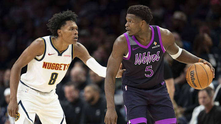 Nov 15, 2025; Minneapolis, Minnesota, USA; Minnesota Timberwolves guard Anthony Edwards (5) dribbles the Ball as Denver Nuggets guard Peyton Watson (8) plays defense in the second half at Target Center.