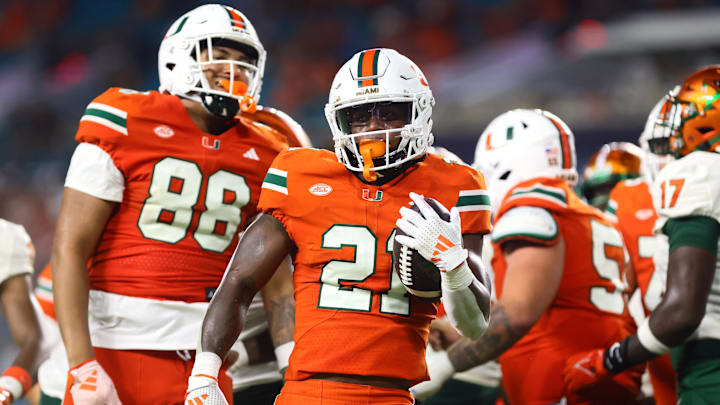 Sep 7, 2024; Miami Gardens, Florida, USA; Miami Hurricanes running back Jordan Lyle (21) reacts after running with the football against the Florida A&M Rattlers during the third quarter at Hard Rock Stadium. Mandatory Credit: Sam Navarro-Imagn Images