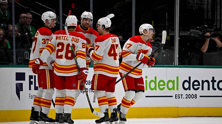 Apr 7, 2026; Dallas, Texas, USA; Calgary Flames defenseman Yan Kuznetsov (37) and defenseman Zach Whitecloud (28) and center Connor Zary (47) and center Yegor Sharangovich (17) celebrates a goal scored by Sharangovich against the Dallas Stars during the second period at the American Airlines Center. Mandatory Credit: Jerome Miron-Imagn Images