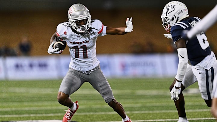 Oct 11, 2024; Logan, Utah, USA;  UNLV Rebels wide receiver Ricky White III (11) runs with the ball against the Utah State Aggies at Merlin Olsen Field at Maverik Stadium. Mandatory Credit: Jamie Sabau-Imagn Images