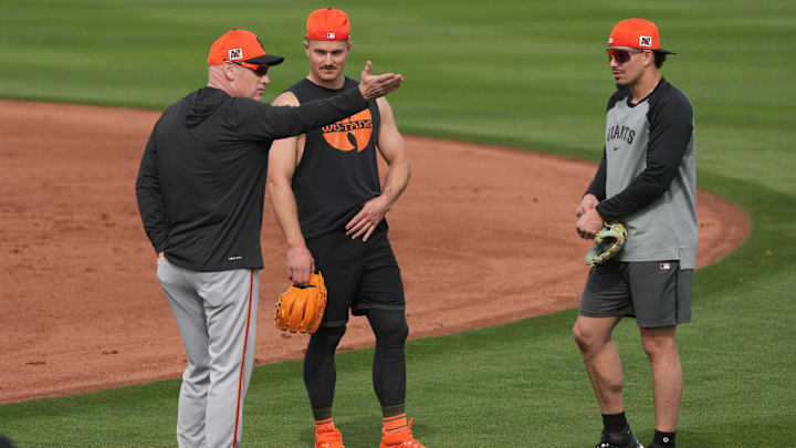 Feb 13, 2025; Scottsdale, AZ, USA; San Francisco Giants coach Matt Williams talks to third base Matt Chapman (26) and shortstop Willy Adames (2) talk during spring training camp. 