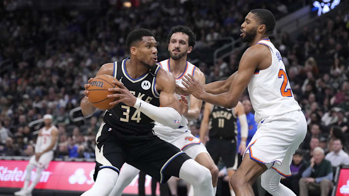 Mar 28, 2025; Milwaukee, Wisconsin, USA; Milwaukee Bucks forward Giannis Antetokounmpo (34) puts up a shot against New York Knicks guard Landry Shamet (44) and New York Knicks forward Mikal Bridges (25) in the first half at Fiserv Forum. Mandatory Credit: Michael McLoone-Imagn Images Mar 28, 2025; Milwaukee, Wisconsin, USA; Milwaukee Bucks forward Giannis Antetokounmpo (34) puts up a shot against New York Knicks guard Landry Shamet (44) and New York Knicks forward Mikal Bridges (25) in the first half at Fiserv Forum. Mandatory Credit: Michael McLoone-Imagn Images