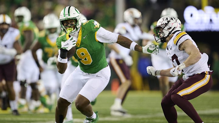 Nov 14, 2025; Eugene, Oregon, USA; Oregon Ducks tight end Jamari Johnson (9) catches a pass for a first down during the first half against Minnesota Golden Gophers defensive back John Nestor (17) at Autzen Stadium. Mandatory Credit: Troy Wayrynen-Imagn Images