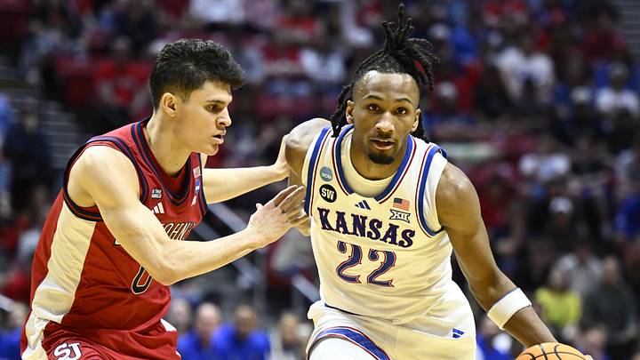 Mar 22, 2026; San Diego, CA, USA; Kansas Jayhawks guard Darryn Peterson (22) controls the ball against St. John's Red Storm guard Dylan Darling (0) in the first half during a second round game of the men's 2026 NCAA Tournament at Viejas Arena. Mandatory Credit: Denis Poroy-Imagn Images