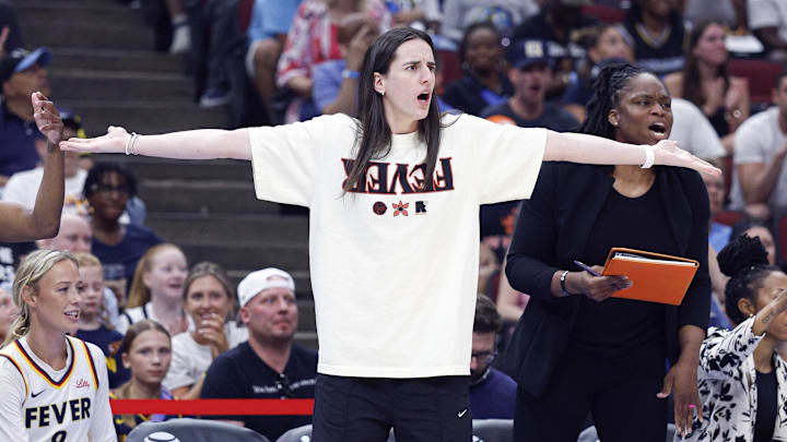 Jul 27, 2025; Chicago, Illinois, USA; Injured Indiana Fever guard Caitlin Clark (22) reacts to a call against her team during the first half of a basketball game against the Chicago Sky at United Center. Mandatory Credit: Kamil Krzaczynski-Imagn Images