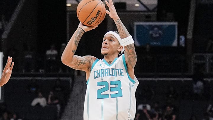 Oct 8, 2024; Charlotte, North Carolina, USA; Charlotte Hornets guard Tre Mann (23) shoots a jumper from three-point range against the Miami Heat during the second half at Spectrum Center. Mandatory Credit: Jim Dedmon-Imagn Images