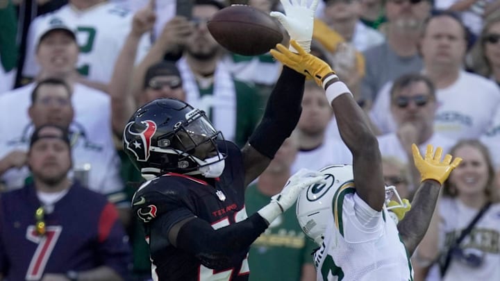 Houston Texans safety Eric Murray (23) break up in the end zone intended for Green Bay Packers wide receiver Dontayvion Wicks (13) during the fourth quarter of their game Sunday, October 20, 2024, at Lambeau Field in Green Bay, Wisconsin. The Green Bay Packers beat the Houston Texans 24-22.