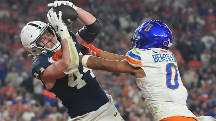 Dec 31, 2024; Glendale, AZ, US; Penn State Nittany Lions tight end Tyler Warren (44) catches a touchdown pass over Boise State Broncos safety Ty Benefield (0) during their Vrbo Fiesta Bowl matchup at State Farm Stadium.