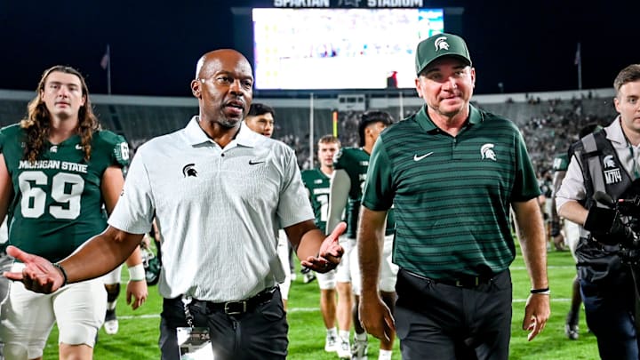 Michigan State football coach Jonathan Smith, right, talks with athletic director Alan Haller after MSU's victory over Florida Atlantic on Friday, Aug. 30, 2024, at Spartan Stadium in East Lansing.