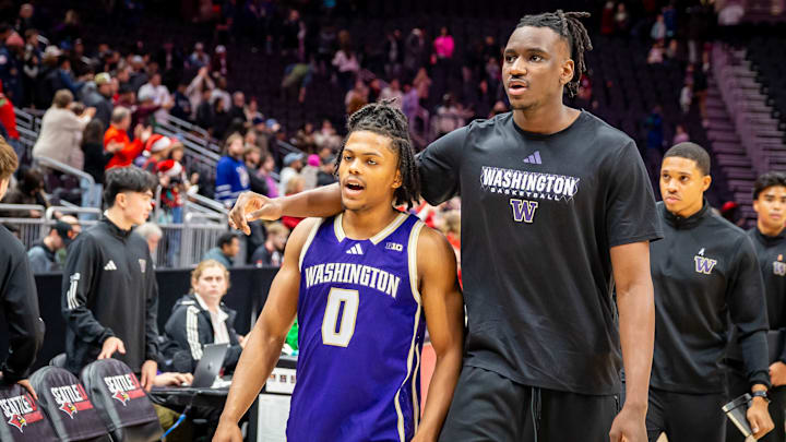 Quimari Peterson (3) and the injured Mady Traore leave the floor after the Seattle U loss. 