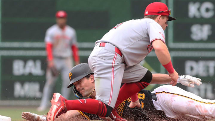 May 21, 2025; Pittsburgh, Pennsylvania, USA; Cincinnati Reds second baseman Matt McLain (9) tags Pittsburgh Pirates second baseman Adam Frazier (26) out at second base on a steal attempt during the eighth inning at PNC Park. Mandatory Credit: Charles LeClaire-Imagn Images May 21, 2025; Pittsburgh, Pennsylvania, USA; Cincinnati Reds second baseman Matt McLain (9) tags Pittsburgh Pirates second baseman Adam Frazier (26) out at second base on a steal attempt during the eighth inning at PNC Park. Mandatory Credit: Charles LeClaire-Imagn Images