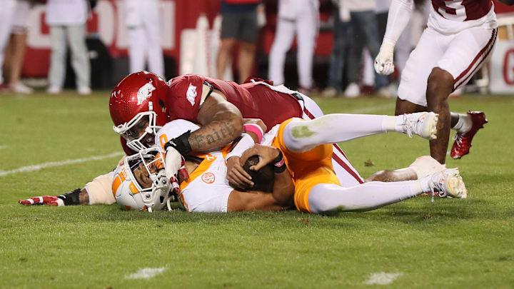 Oct 5, 2024; Fayetteville, Arkansas, USA; Arkansas Razorbacks defensive lineman Cameron Ball (5) sacks Tennessee Volunteers quarterback Nico Iamaleava (8) during the second quarter at Donald W. Reynolds Razorback Stadium. Mandatory Credit: Nelson Chenault-Imagn Images